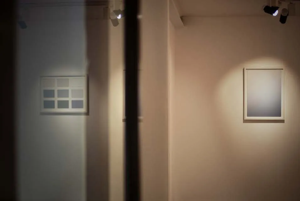 Framed acrylic glass panels on a gallery wall