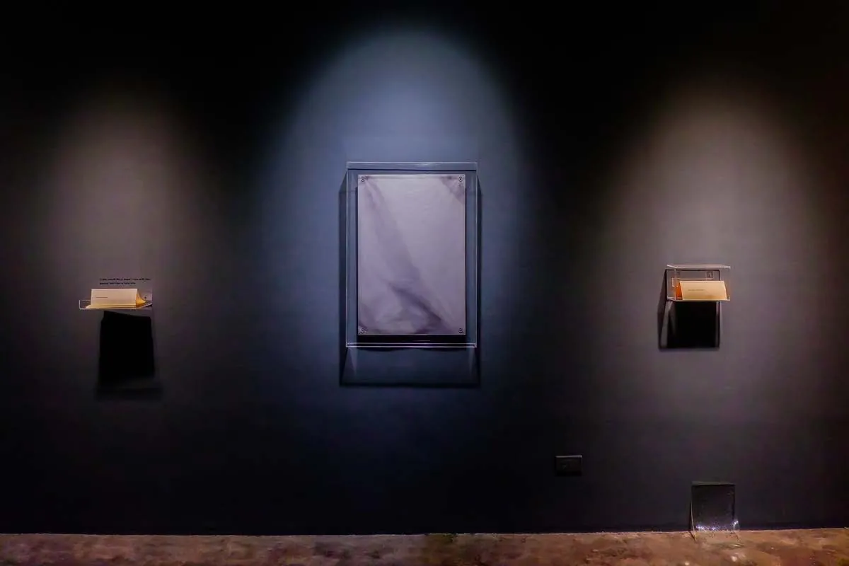Installation view of Iterations, Parallax of Memory and Withheld on a dark wall