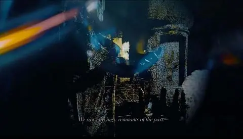 Video still: a carved temple wall breaking into blue and gold light, with the subtitle We saw carvings, remnants of the past