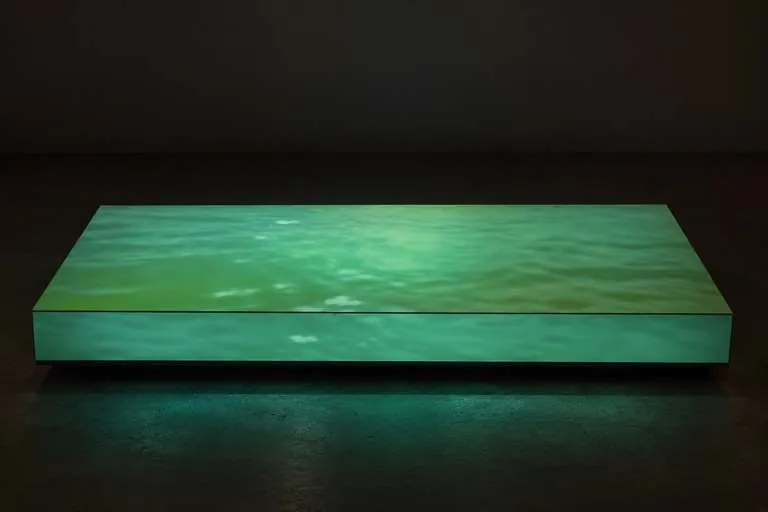 The floor lightbox glowing green in a dark room