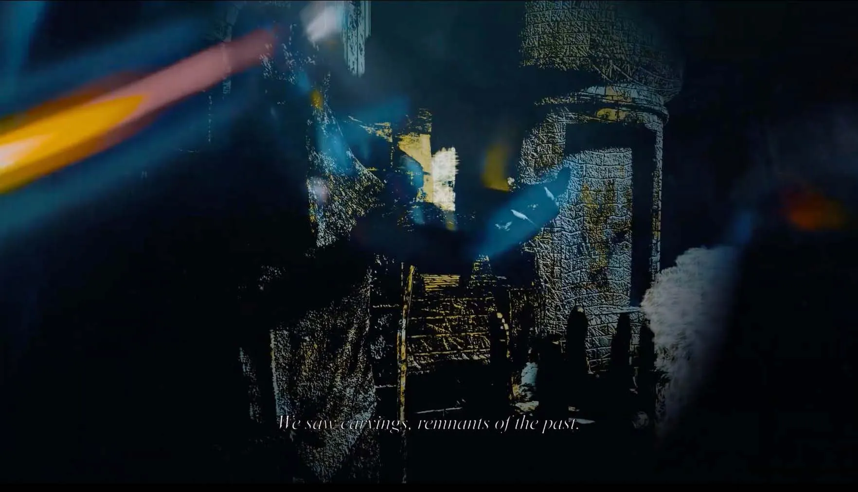 Video still: a carved temple wall breaking into blue and gold light, with the subtitle We saw carvings, remnants of the past